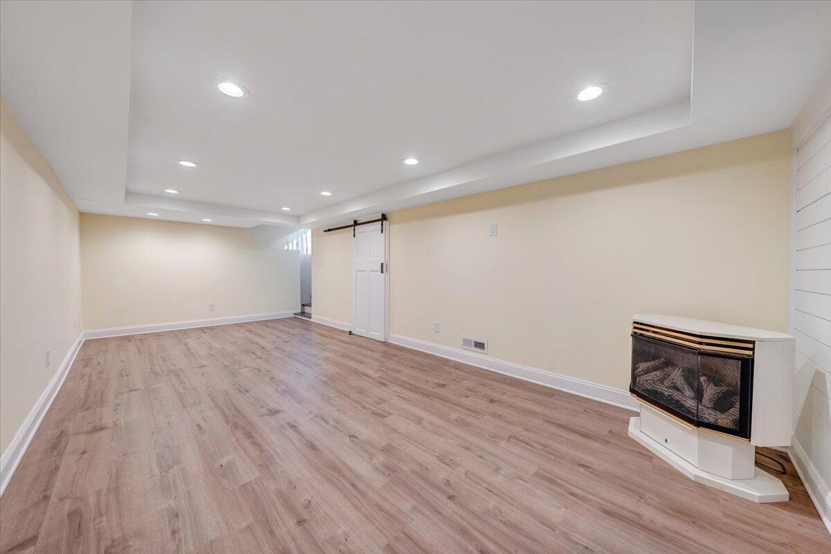 3804 Meadowlark Road Roanoke, VA 24018 - Photo 29 of 54 a view of an empty room with wooden floor and a fireplace