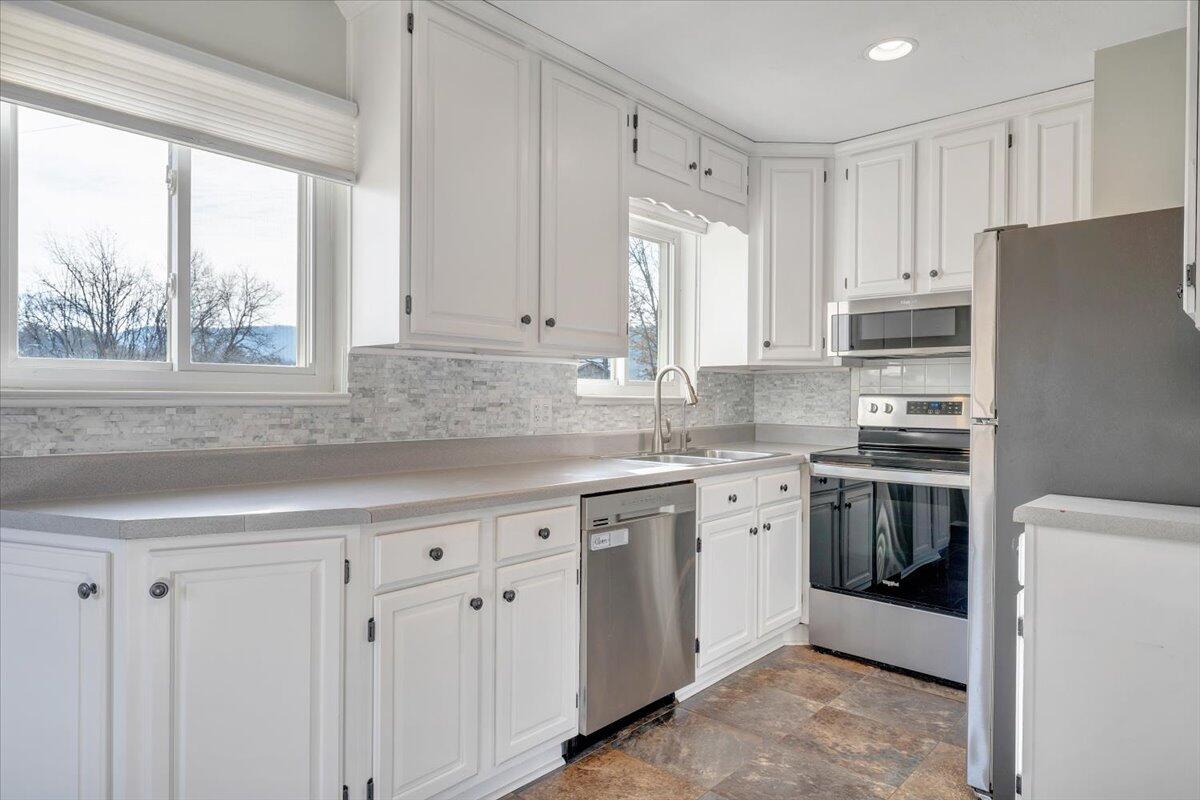 3804 Meadowlark Road Roanoke, VA 24018 - Photo 9 of 54 a kitchen with stainless steel appliances granite countertop a stove a sink and a refrigerator