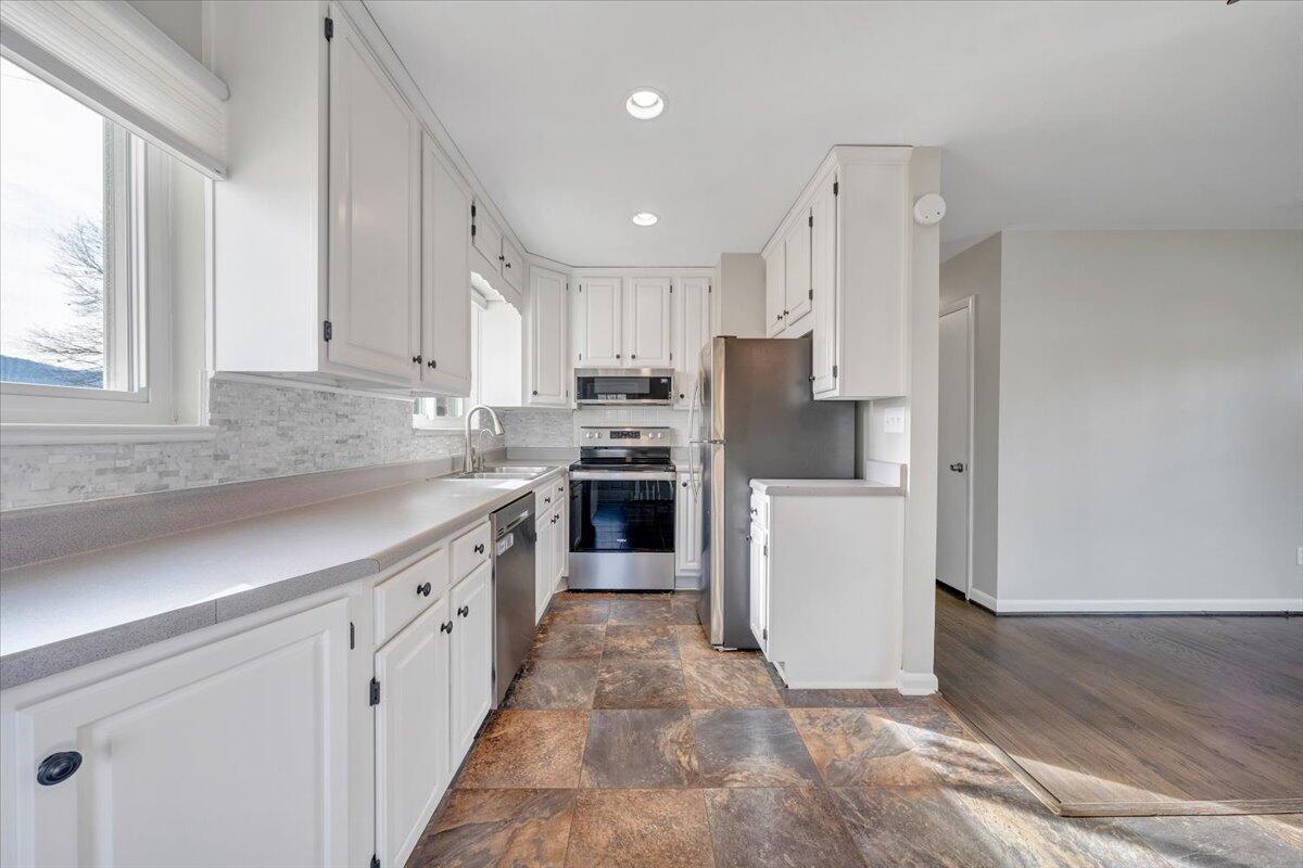 3804 Meadowlark Road Roanoke, VA 24018 - Photo 10 of 54 a kitchen with stainless steel appliances granite countertop a refrigerator sink and cabinets