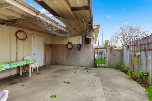 a view of a porch with furniture and a yard