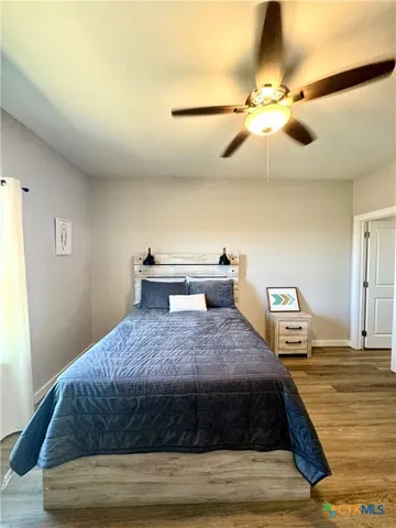 a bedroom with a bed and wooden floor