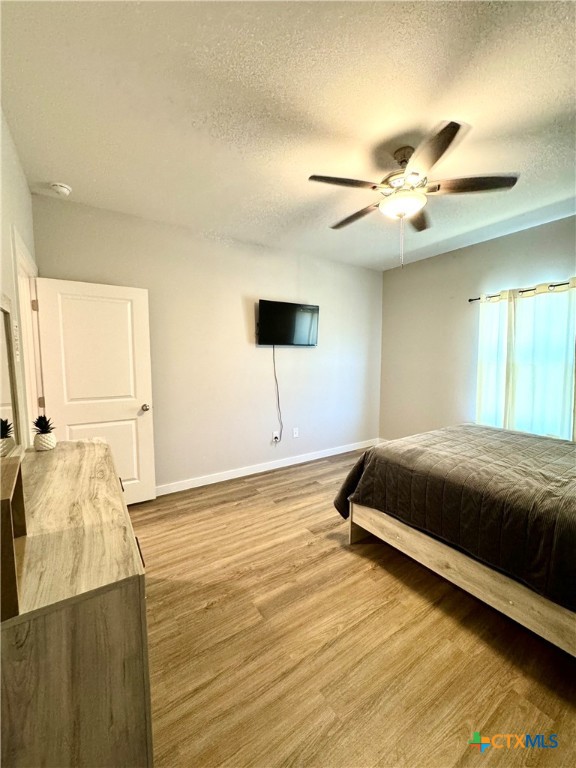 4022 Keller Road, Unit B Temple, TX 76504 - Photo 20 of 34 a bedroom with a bed and a chandelier