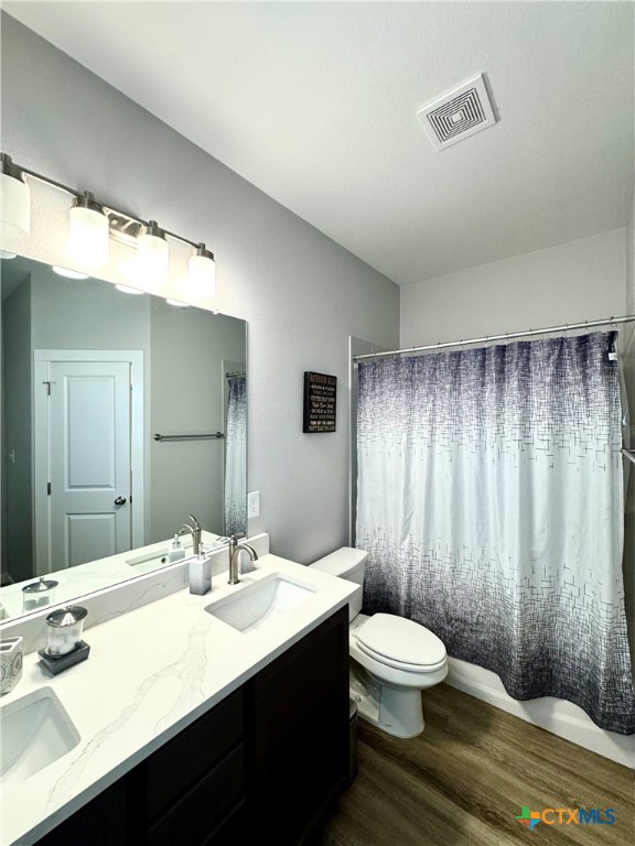 4022 Keller Road, Unit B Temple, TX 76504 - Photo 21 of 34 a bathroom with a double vanity sink toilet a mirror and shower