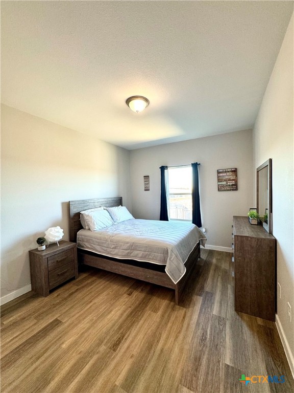 4022 Keller Road, Unit B Temple, TX 76504 - Photo 24 of 34 a bedroom with a bed and wooden floor