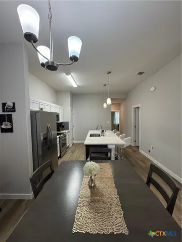 a kitchen with a table and chairs in it