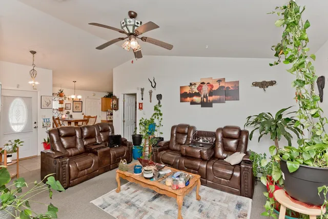 a living room with furniture flowers and a chandelier