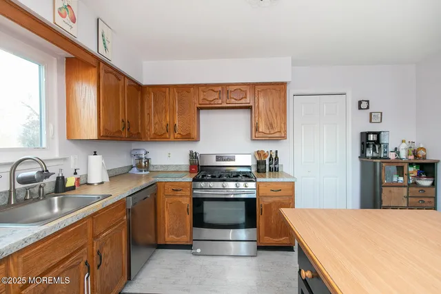 a kitchen with a stove a sink and a refrigerator