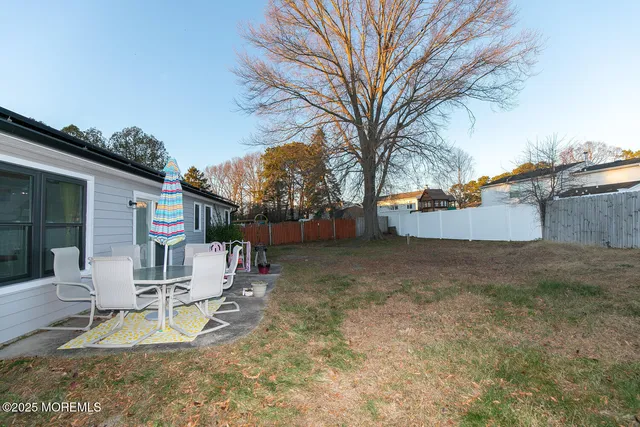 a view of a house with a yard and sitting area