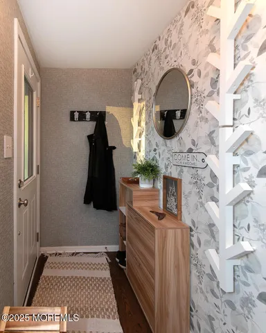 a view of entryway with a fireplace and wooden floor