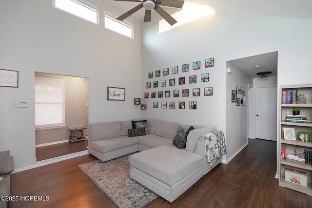a living room with furniture and a book shelf