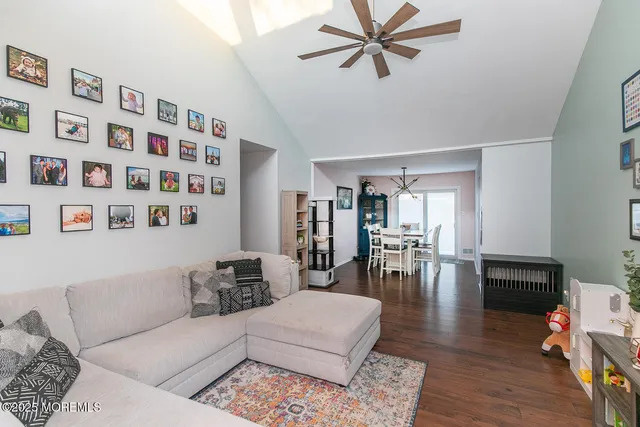 a living room with furniture and wooden floor
