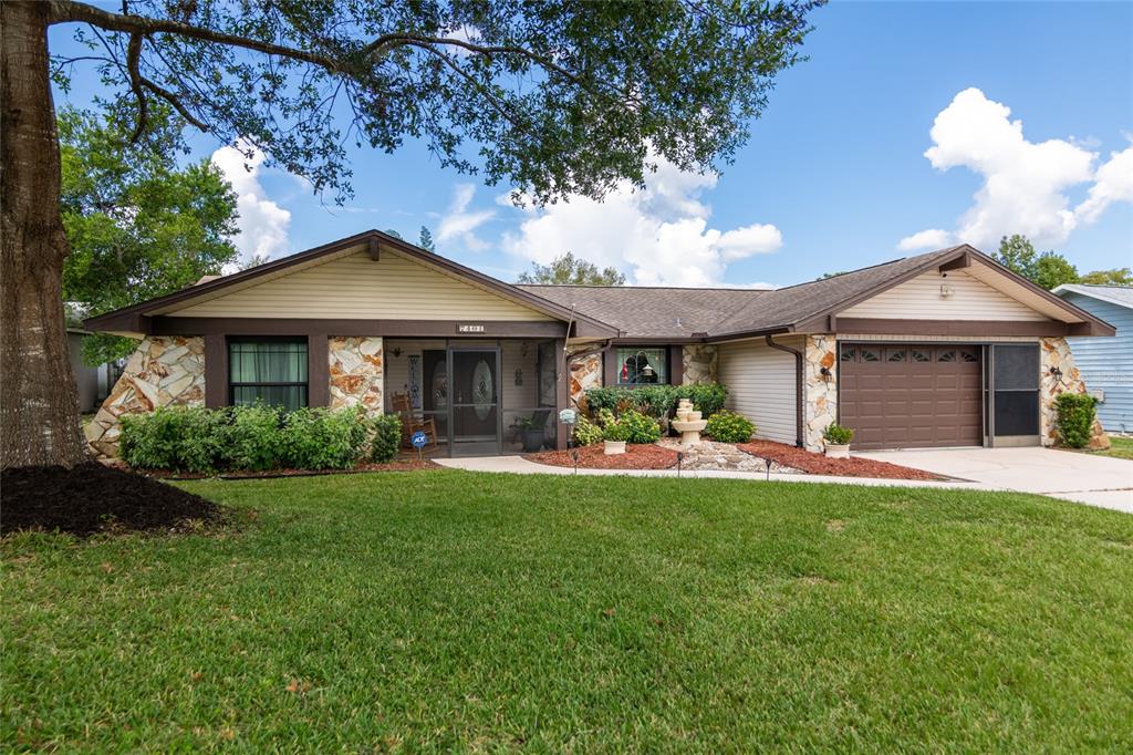 7401 Galloway Road Weeki Wachee, FL 34613 - Photo 1 of 1 a front view of a house with a garden and porch