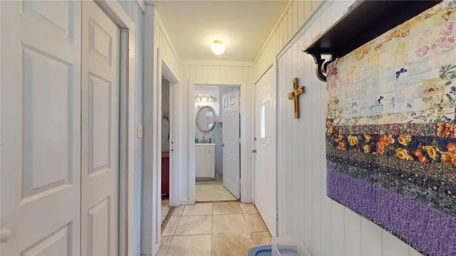 a view of a hallway with wooden shelves