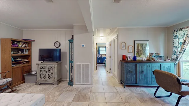 a view of a workspace with furniture and a flat screen tv