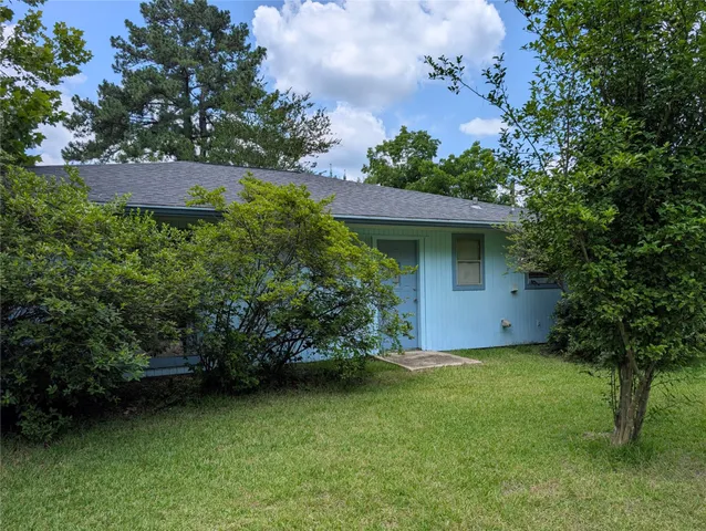 a view of a porch with hardwood and front view of a house