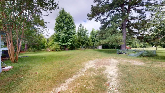 a view of green field with trees