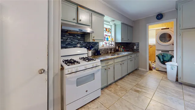 a kitchen with a stove top oven sink and cabinets