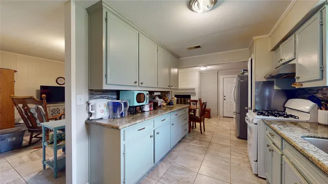 a kitchen with a sink stove and cabinets
