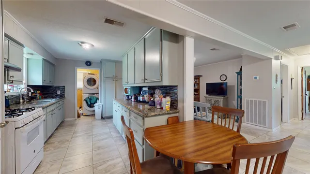 a large kitchen with a table and chairs