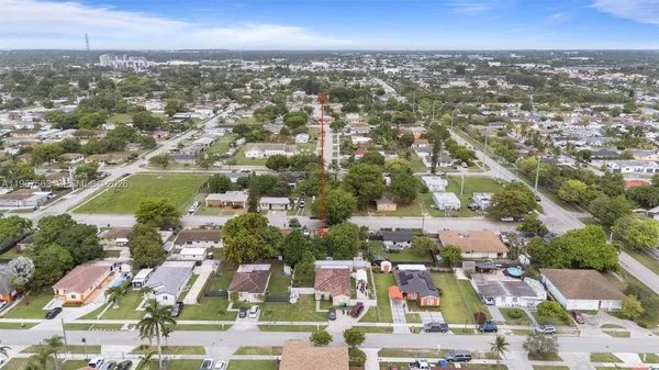 an aerial view of residential houses with city view