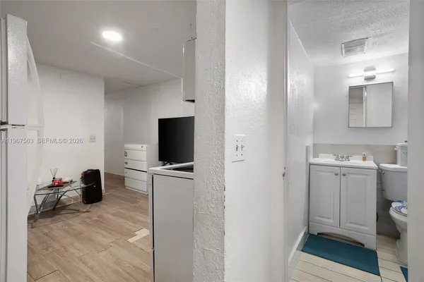 a view of a bathroom with a sink and a mirror