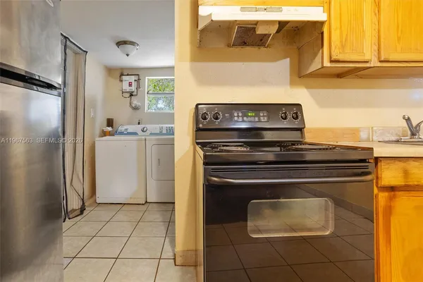 a kitchen with a stove and a refrigerator