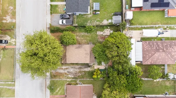 an aerial view of a house with a yard basket ball court and outdoor seating