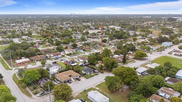 an aerial view of residential houses with city view