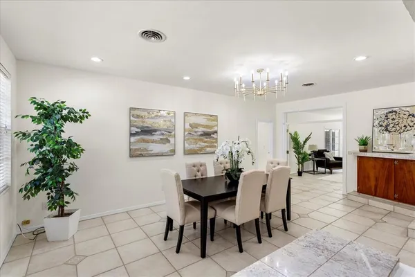 a view of a dining room with furniture and chandelier