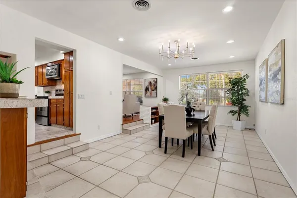 a dining room with furniture and chandelier