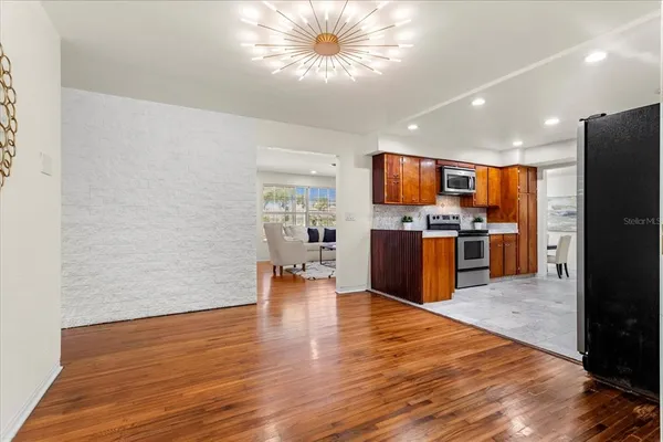 a kitchen with stainless steel appliances a refrigerator and a stove top oven