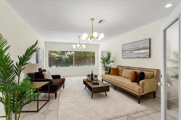 a living room with furniture and a chandelier