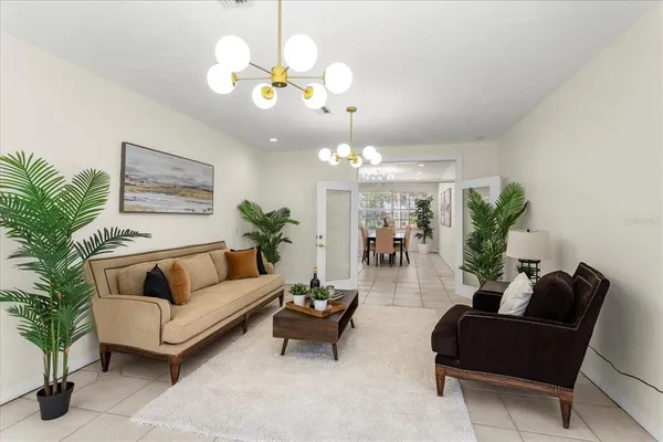 a living room with furniture chandelier and a chandelier