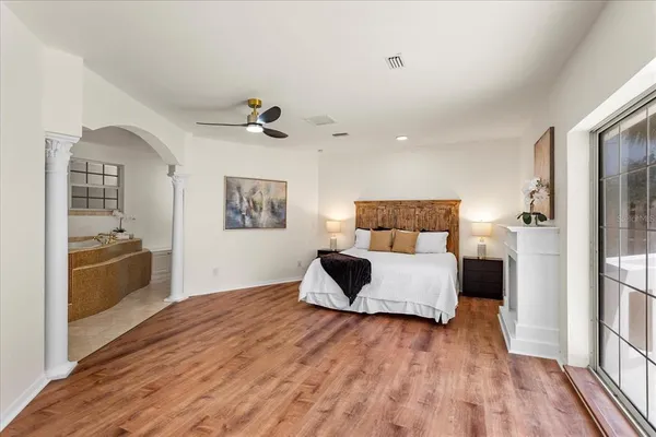 a bedroom with a bed and a view of kitchen