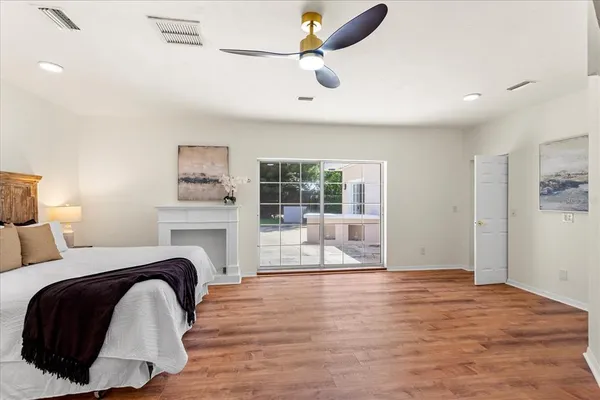 a spacious bedroom with a bed and glass window