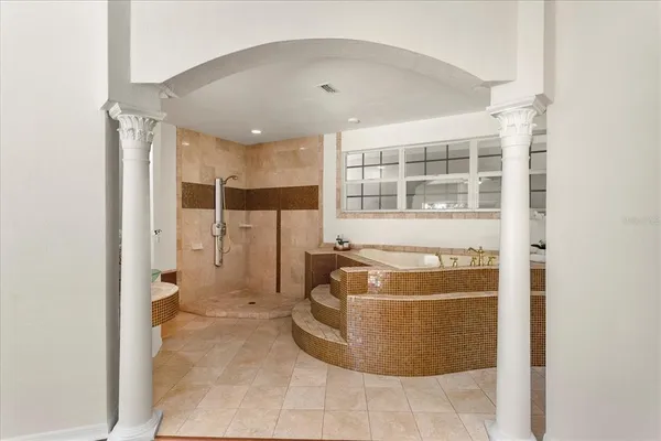 a living room with a couch and a potted plant