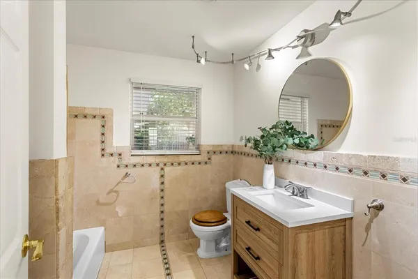 a bathroom with a toilet sink and mirror