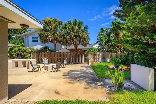a backyard of a house with table and chairs
