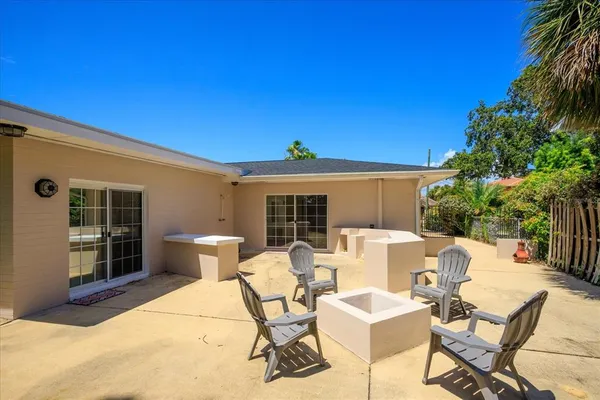 a view of a patio with a table and chairs and potted plants