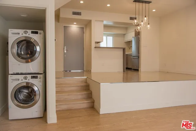 a view of a hallway with washer and dryer