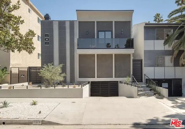 a view of a building with potted plants