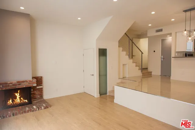 a view of a living room with a fireplace