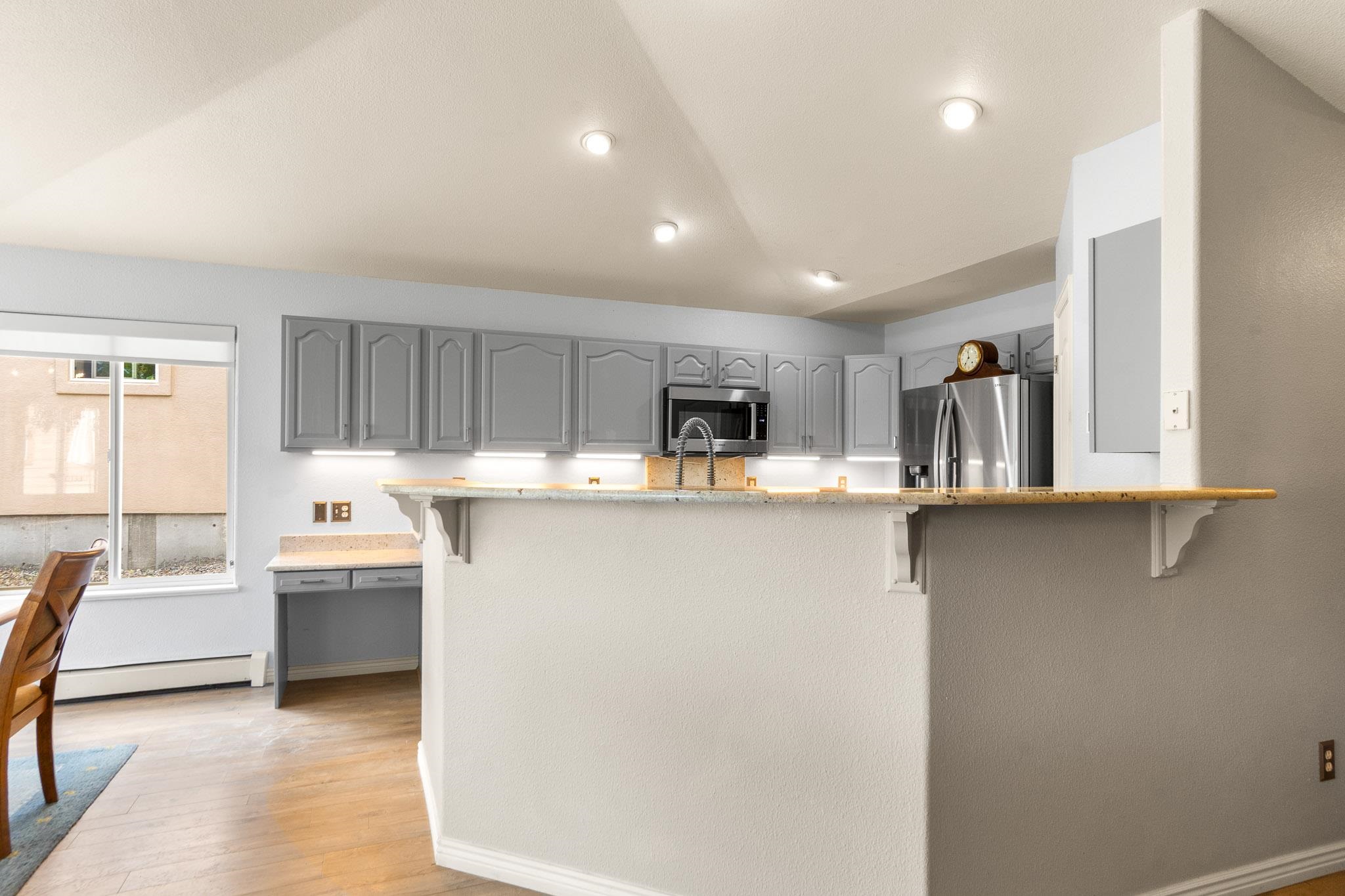 398 Butte Court Grand Junction, CO 81507 - Photo 10 of 33 a kitchen with stainless steel appliances granite countertop a refrigerator and a stove top oven