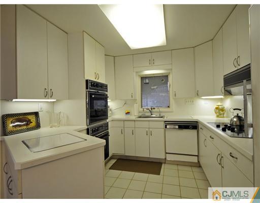 7 Edgewood Road Old Bridge, NJ 07747 - Photo 5 of 16 a kitchen with a stove and a refrigerator