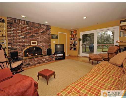 7 Edgewood Road Old Bridge, NJ 07747 - Photo 7 of 16 a bedroom with furniture and a fireplace