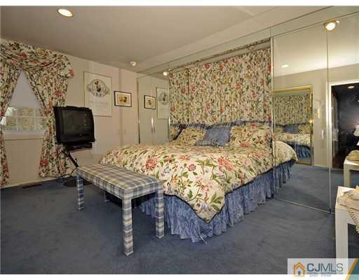 7 Edgewood Road Old Bridge, NJ 07747 - Photo 8 of 16 a bedroom with a bed and flat screen tv