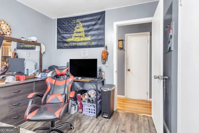 a view of a livingroom with furniture and a flat screen tv