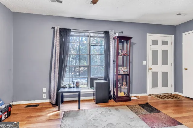 a bedroom with furniture and large window