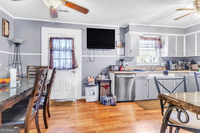 a view of a kitchen with furniture and a flat screen tv