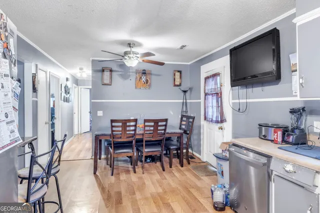 a dining room with furniture and wooden floor